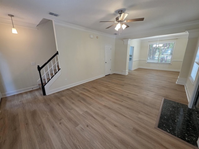 9369 Buck Haven Trl, Tallahassee, FL 32312 - unfurnished living room with a chandelier, stairs, a ceiling fan, wood finished floors, and ornamental molding