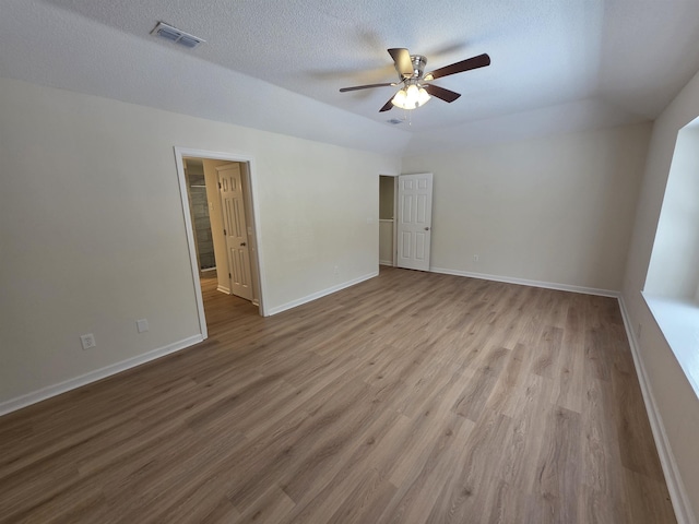 9369 Buck Haven Trl, Tallahassee, FL 32312 - empty room with ceiling fan, wood finished floors, and a textured ceiling