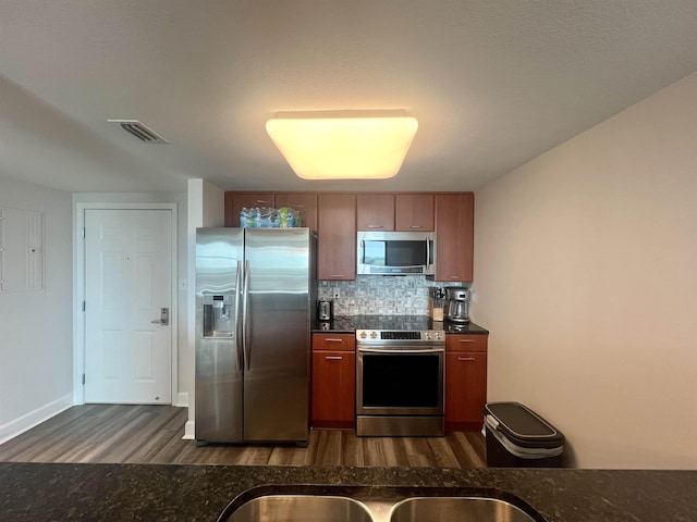 300 S Duval St Unit 1602, Tallahassee, FL 32301 - kitchen featuring stainless steel appliances, dark wood-style floors, backsplash, and brown cabinetry