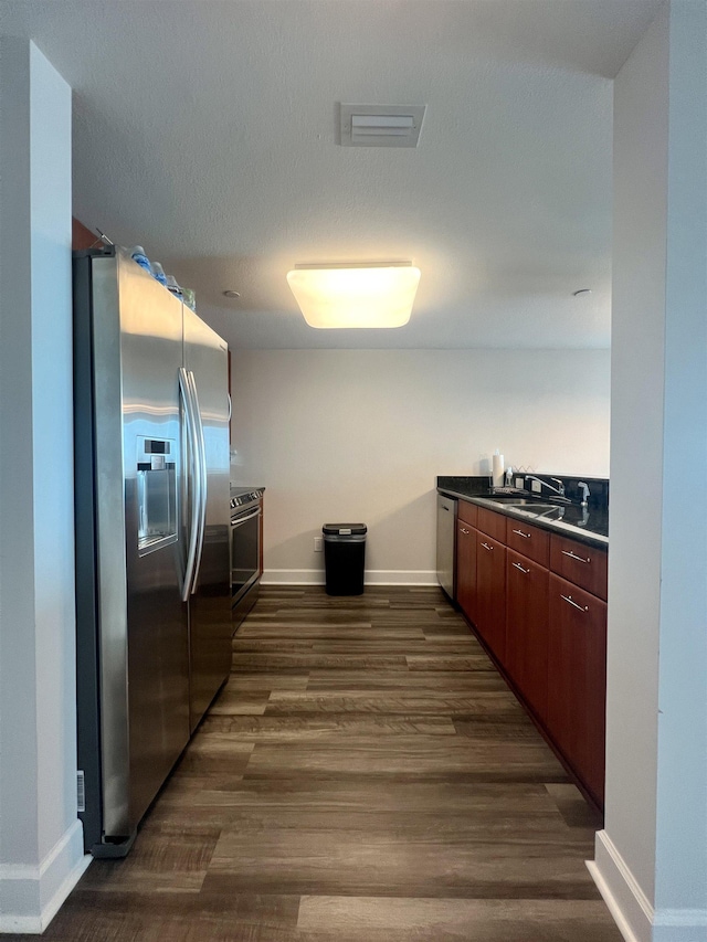 300 S Duval St Unit 1602, Tallahassee, FL 32301 - kitchen with appliances with stainless steel finishes, dark countertops, and dark wood-style floors