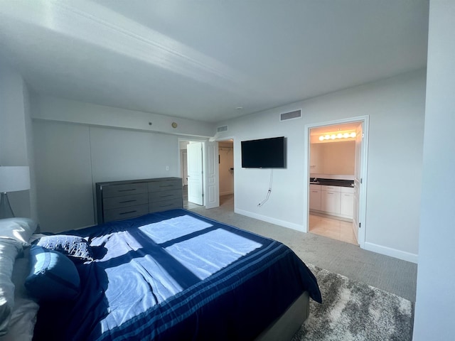 300 S Duval St Unit 1602, Tallahassee, FL 32301 - bedroom with light colored carpet and ensuite bathroom