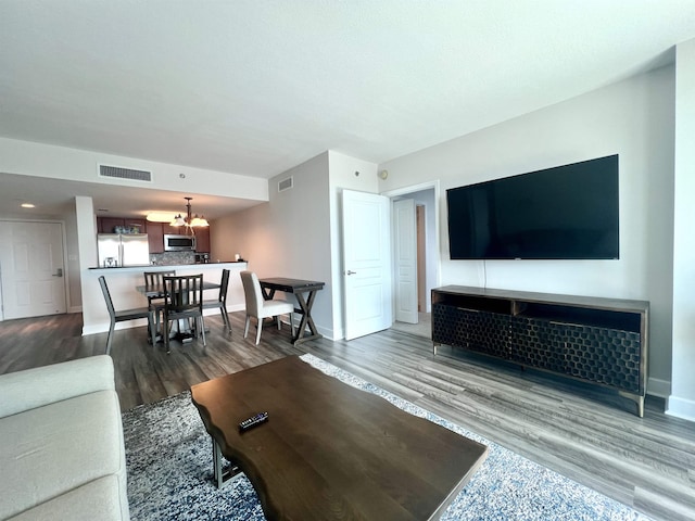 300 S Duval St Unit 1602, Tallahassee, FL 32301 - living room featuring a chandelier and wood finished floors
