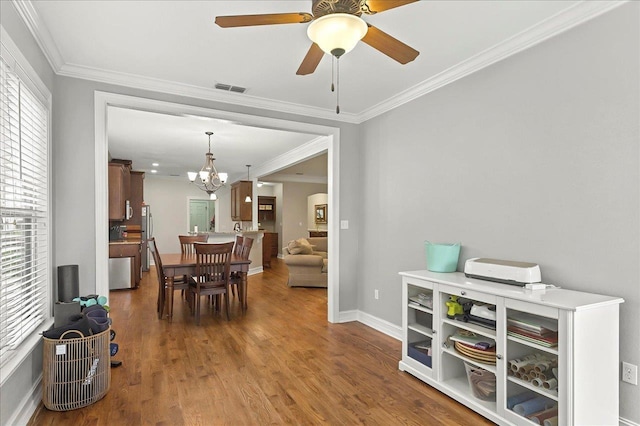 2617 Manassas Way, Tallahassee, FL 32312 - dining room with a chandelier, ornamental molding, wood finished floors, and a ceiling fan
