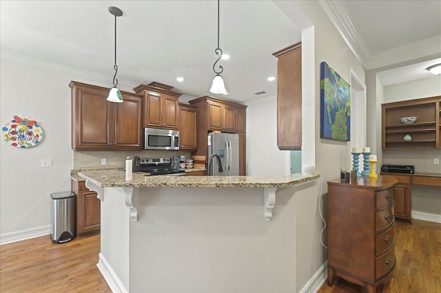 2617 Manassas Way, Tallahassee, FL 32312 - kitchen featuring stainless steel appliances, a kitchen bar, ornamental molding, light stone countertops, and wood finished floors