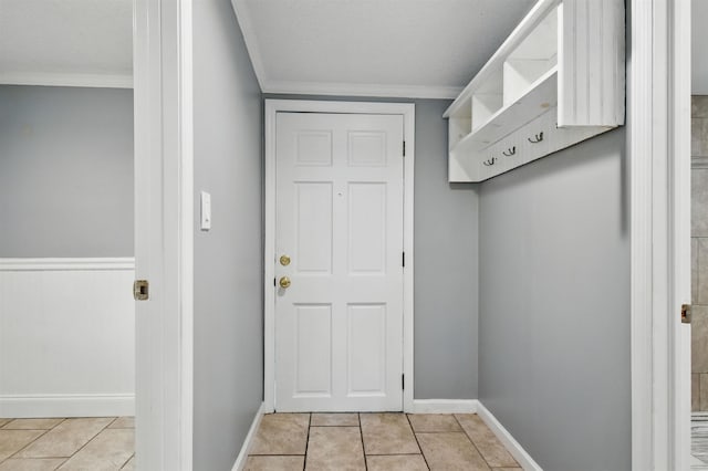 802 N Quincy St, Perry, FL 32347 - mudroom with crown molding, light tile patterned floors, and baseboards