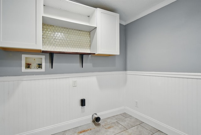802 N Quincy St, Perry, FL 32347 - washroom featuring cabinet space, electric dryer hookup, hookup for a washing machine, a wainscoted wall, and light tile patterned flooring