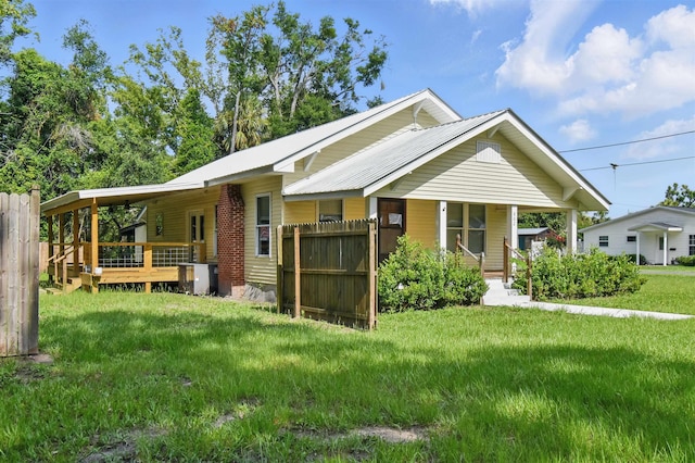 802 N Quincy St, Perry, FL 32347 - view of front facade with metal roof, a deck, and covered porch