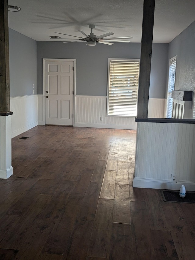 interior space featuring ceiling fan and dark wood-type flooring