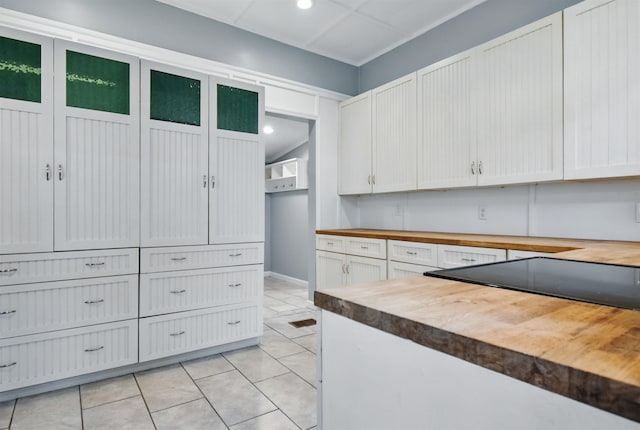 802 N Quincy St, Perry, FL 32347 - kitchen with wooden counters, white cabinetry, recessed lighting, and light tile patterned floors