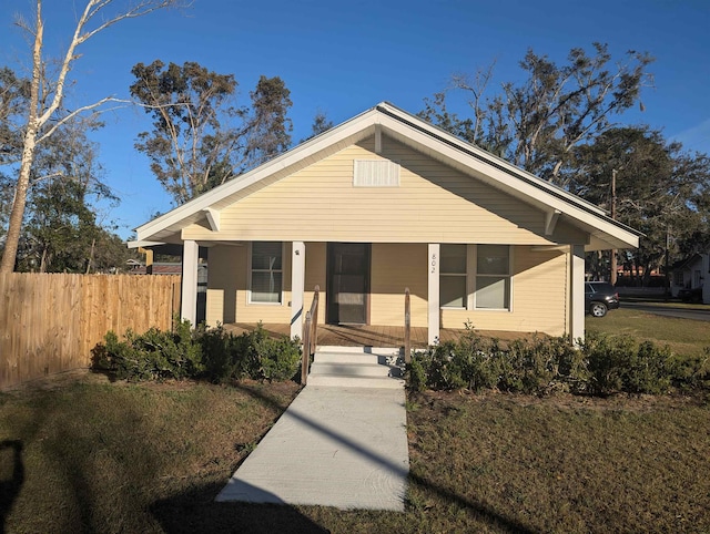 view of front of house with a porch and a front yard