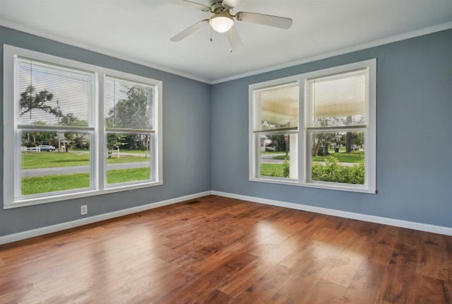 802 N Quincy St, Perry, FL 32347 - empty room featuring crown molding, baseboards, wood finished floors, and ceiling fan