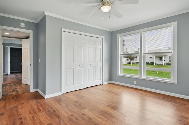 802 N Quincy St, Perry, FL 32347 - unfurnished bedroom featuring baseboards, wood finished floors, ornamental molding, a closet, and ceiling fan