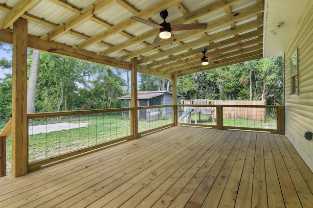 802 N Quincy St, Perry, FL 32347 - wooden deck with ceiling fan, view of wooded area, and an outbuilding