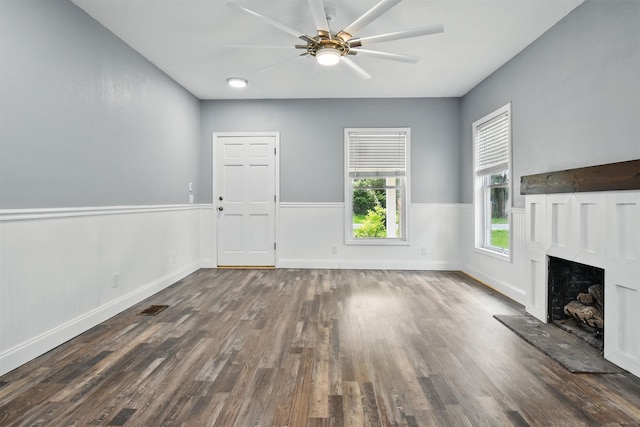 802 N Quincy St, Perry, FL 32347 - unfurnished living room featuring wood finished floors, a ceiling fan, a premium fireplace, and baseboards