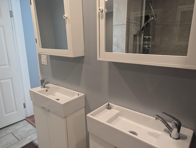 bathroom featuring tile patterned flooring, vanity, and walk in shower