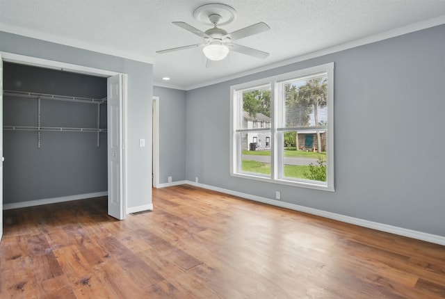 802 N Quincy St, Perry, FL 32347 - unfurnished bedroom featuring wood finished floors, a closet, baseboards, and ceiling fan
