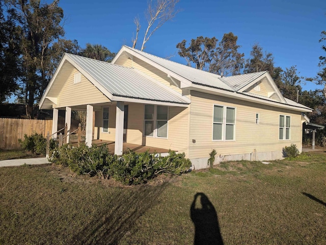 view of side of property with a yard and a porch