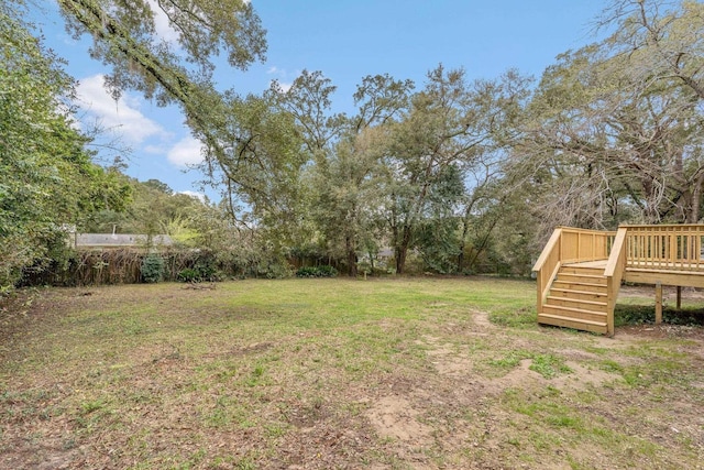 view of yard featuring a wooden deck and stairs