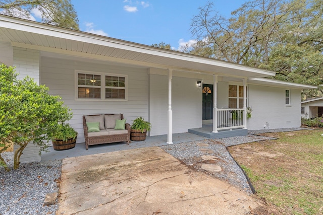 view of front of home with brick siding and a porch