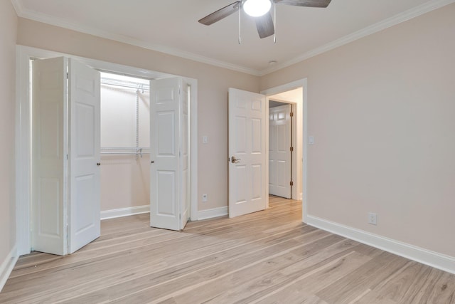 unfurnished bedroom with light wood-type flooring, baseboards, and crown molding