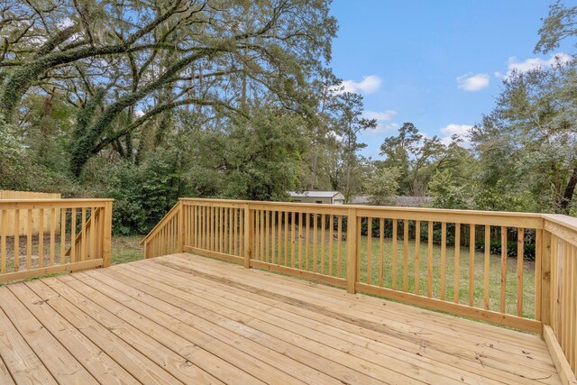 deck featuring a storage shed and an outdoor structure