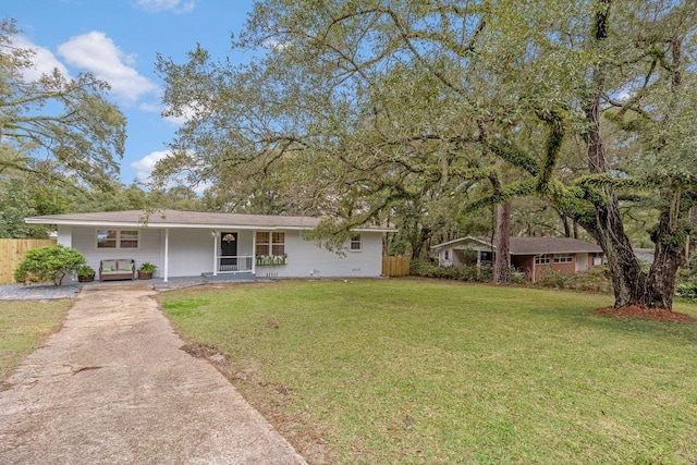 single story home with a front yard, a porch, and fence