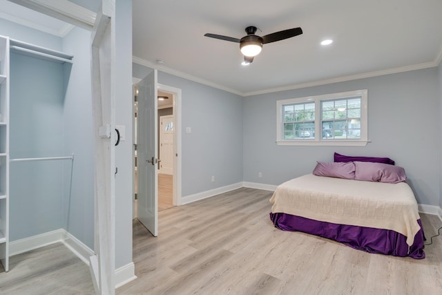 bedroom featuring ceiling fan, baseboards, wood finished floors, and ornamental molding