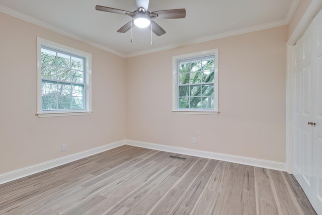 unfurnished room featuring baseboards, light wood-style floors, ceiling fan, and crown molding