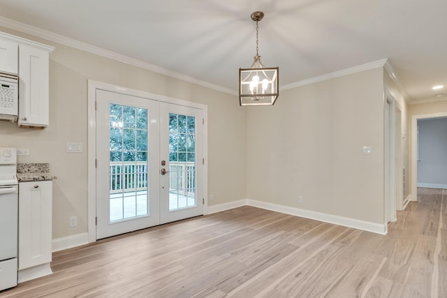 unfurnished dining area with french doors, baseboards, light wood-style floors, and crown molding