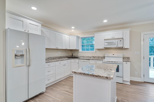 kitchen with white appliances, white cabinets, light wood-style floors, and ornamental molding