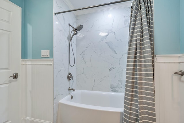 bathroom with shower / tub combo with curtain and wainscoting