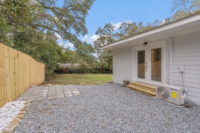 view of yard featuring a patio area, entry steps, a fenced backyard, and ac unit