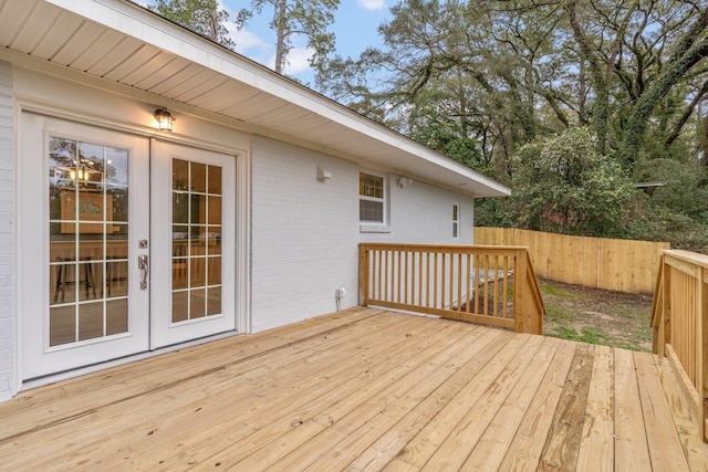 wooden terrace featuring french doors and fence