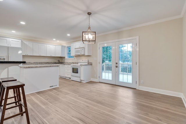 kitchen with light wood-style flooring, white appliances, white cabinetry, and crown molding