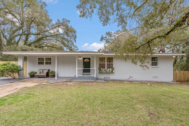 ranch-style home featuring brick siding, a front lawn, fence, covered porch, and crawl space