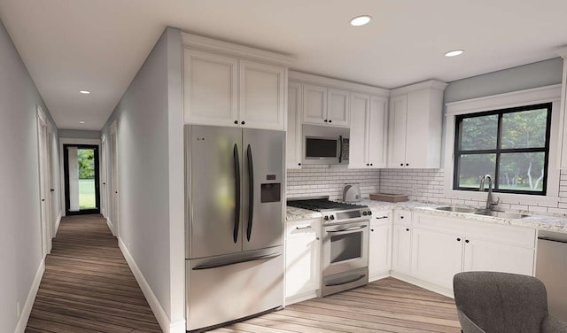 947 Cap Tram Rd, Tallahassee, FL 32317 - kitchen featuring stainless steel appliances, light wood finished floors, tasteful backsplash, and recessed lighting