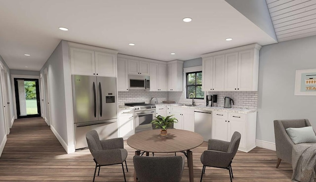 947 Cap Tram Rd, Tallahassee, FL 32317 - kitchen with stainless steel appliances, tasteful backsplash, wood finished floors, white cabinets, and recessed lighting
