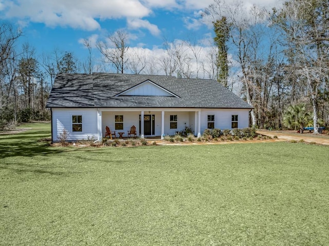 view of front of home with covered porch and a front yard