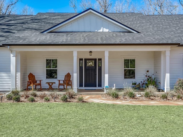 entrance to property featuring a yard and a porch