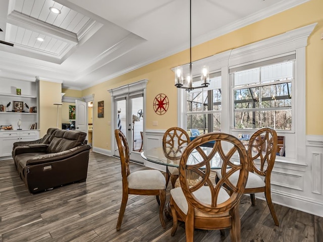 dining area with french doors, crown molding, an inviting chandelier, and dark hardwood / wood-style flooring