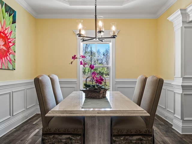 dining space with crown molding, dark hardwood / wood-style floors, and a notable chandelier