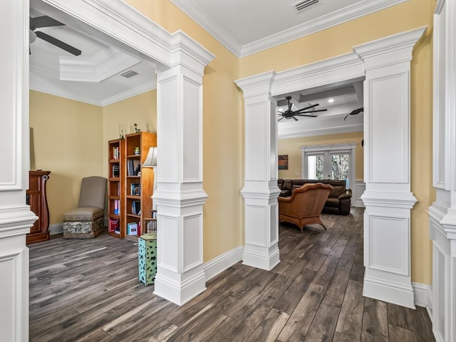 corridor with dark hardwood / wood-style flooring, crown molding, and decorative columns