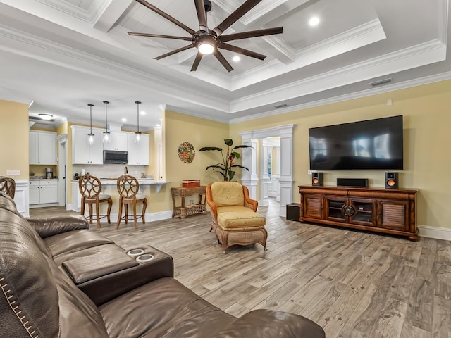 living room featuring light wood-type flooring, crown molding, and ceiling fan