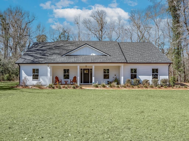 view of front of home with covered porch and a front lawn