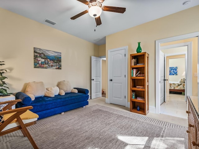 sitting room featuring light colored carpet and ceiling fan