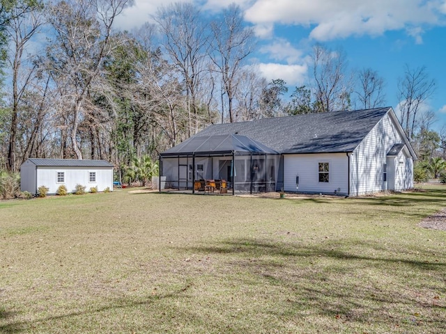 rear view of property with a yard and a lanai