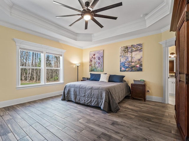 bedroom with a tray ceiling, ornamental molding, dark wood-type flooring, and ceiling fan