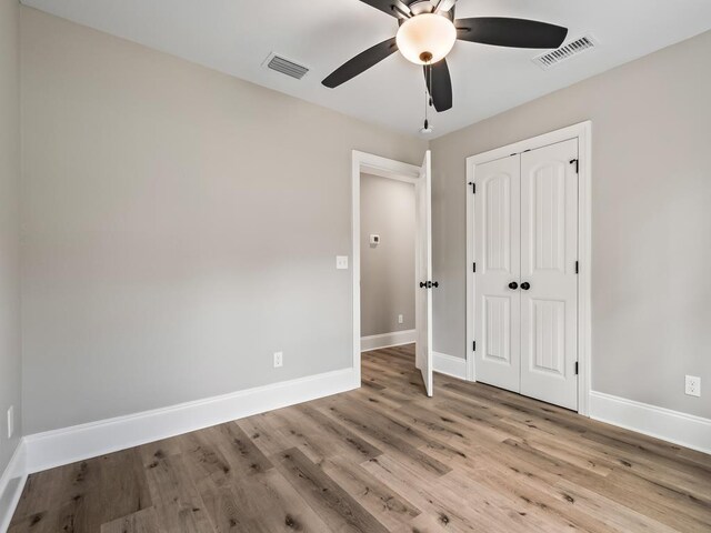 17 Broken Bow Trl, Crawfordville, FL 32327 - unfurnished bedroom featuring baseboards, wood finished floors, a closet, and ceiling fan