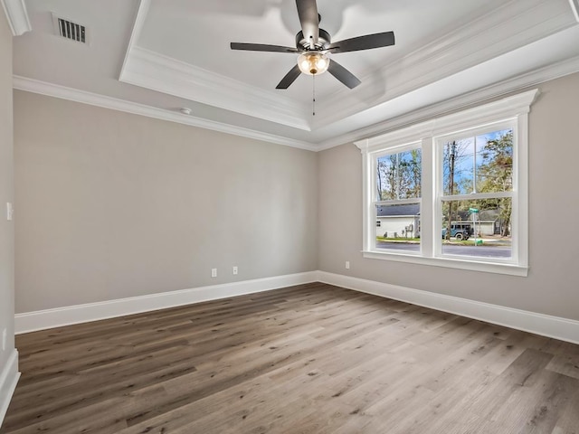 17 Broken Bow Trl, Crawfordville, FL 32327 - empty room with a raised ceiling, crown molding, wood finished floors, a ceiling fan, and baseboards