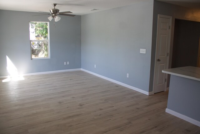 spare room with ceiling fan and light wood-type flooring